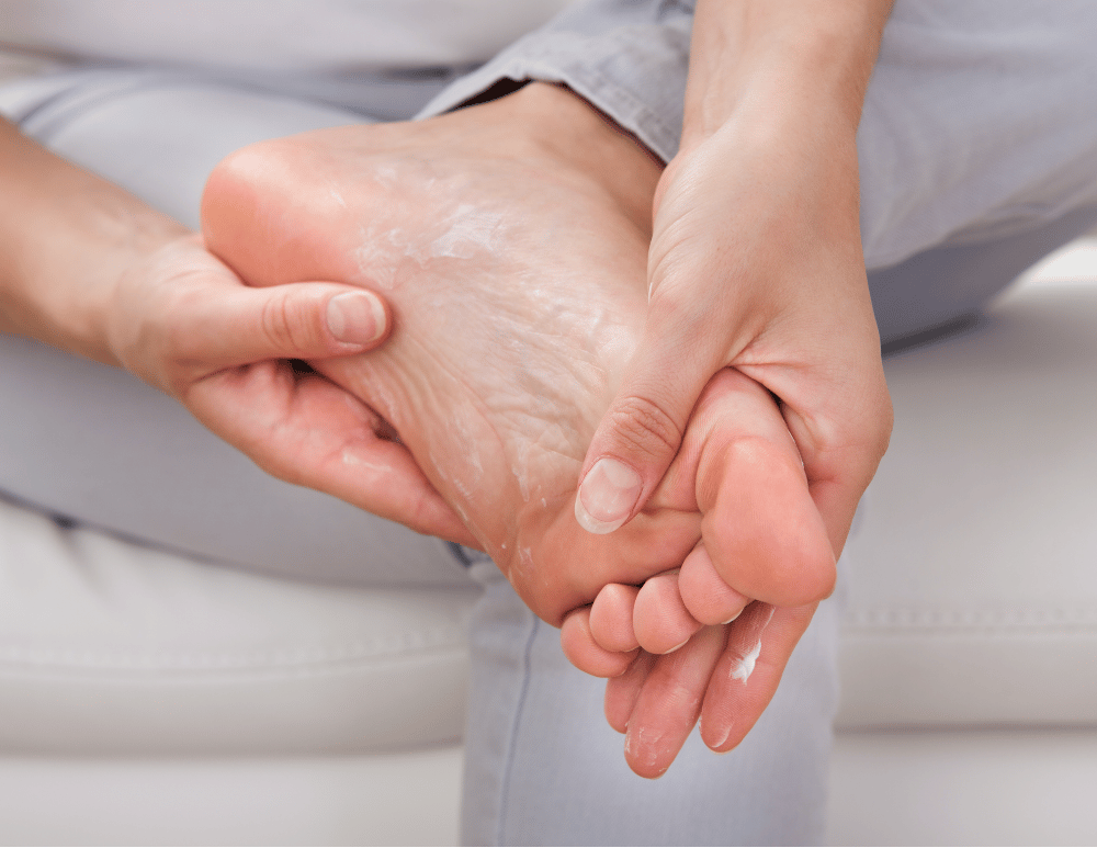 Woman rubbing lotion on foot for diabetic foot care